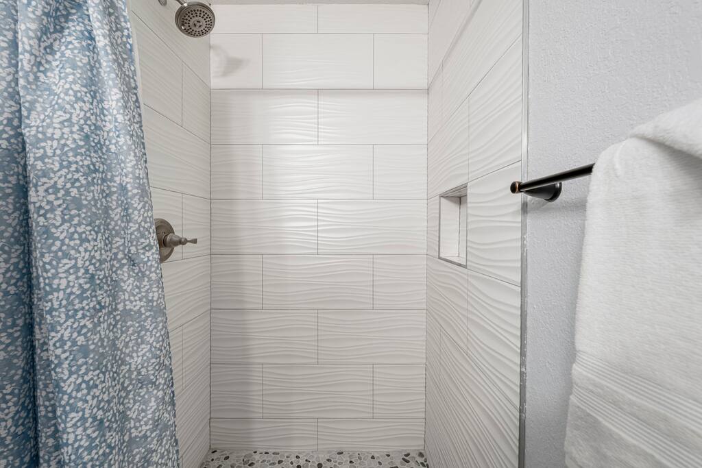 Shower area in the downstairs bathroom 5 min to Beach. Free golf cart. Fenced backyard