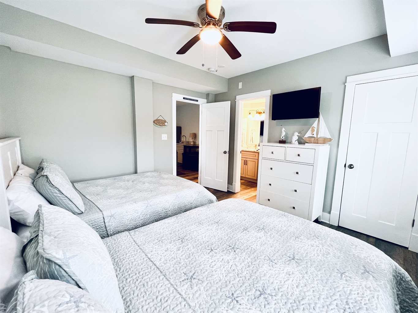 Twin bed, wooden floors, and a pair of windows for a welcoming ambiance.
