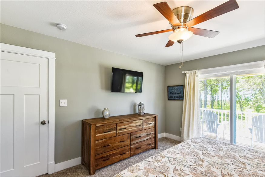 The view from the bed reveals a well-appointed dressing table and a wall-mounted TV for added comfort and convenience.