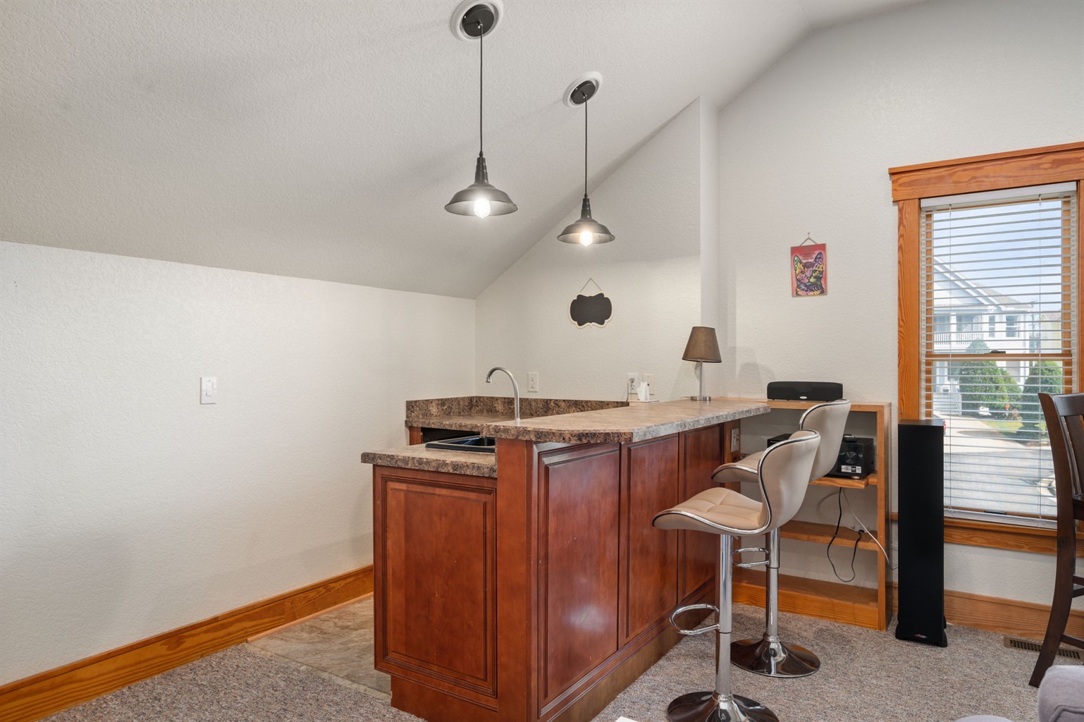Additional living room with wet bar.