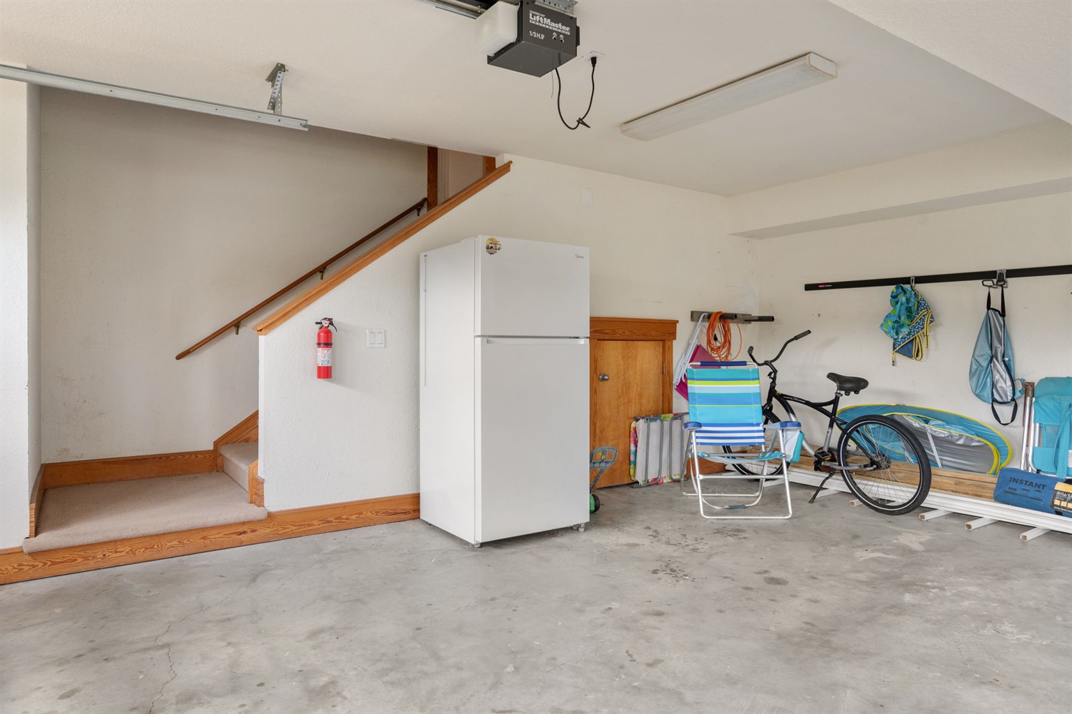 Garage with additional fridge.