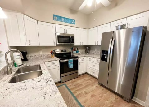 Granite countertops and stainless appliances - fully equipped kitchen.