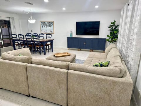 Experience the welcoming vibes of our open-concept living room, where conversations flow seamlessly whether you're lounging on the couch or gathered around the dining room table. It's all about connec