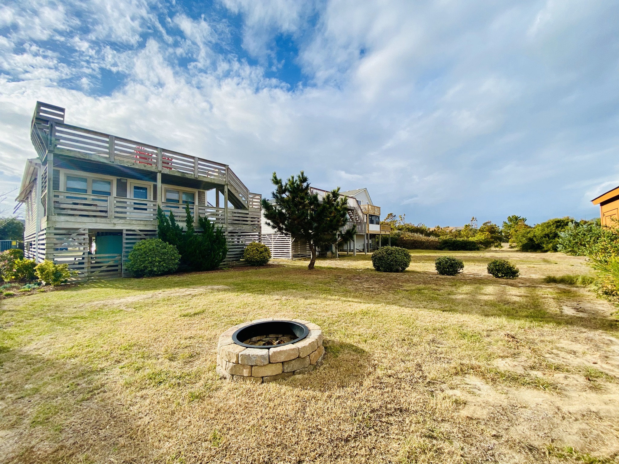 Back of the house with backyard fire pit. - Claire Skies - 75 yards to beach access! - Nags Head