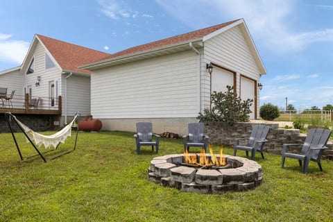 The backyard beckons with a hammock and a firepit with a small supply of wood included. The firepit is situated to offer a an unobstructed view of the lake, and after dark the twinkling lights of Shell Knob