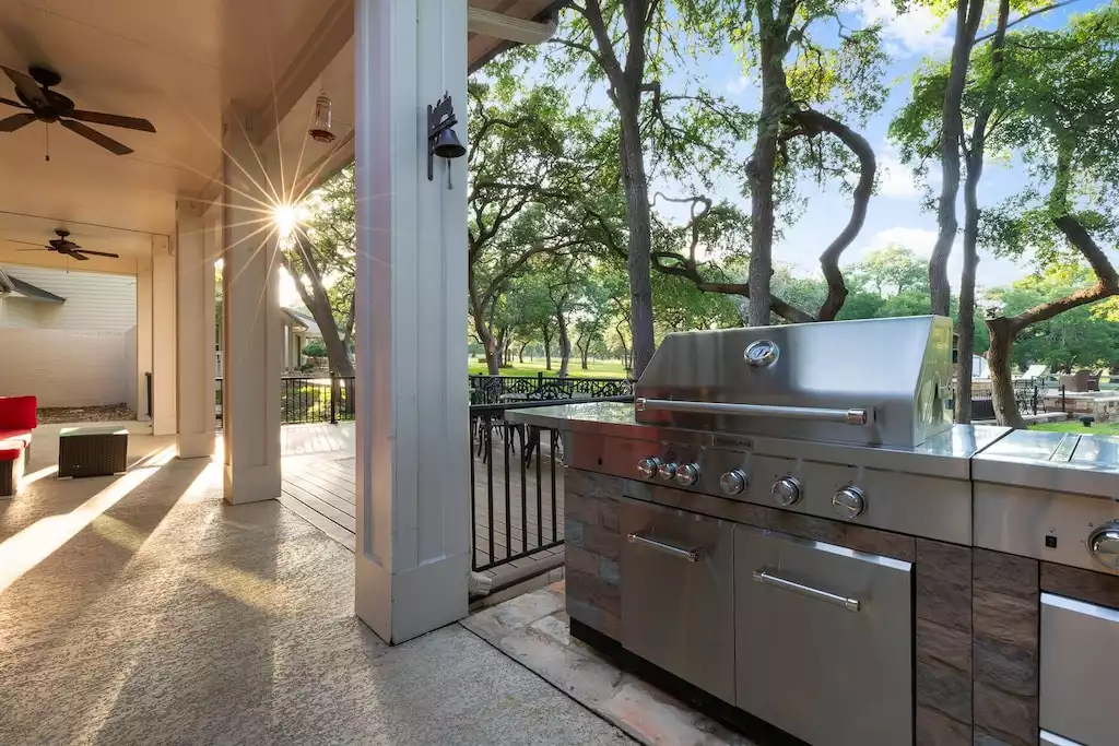 Off the kitchen and informal dining area is the propane barbecue grill and deck. - Main House at Whispering Oaks Estate - Dripping Springs