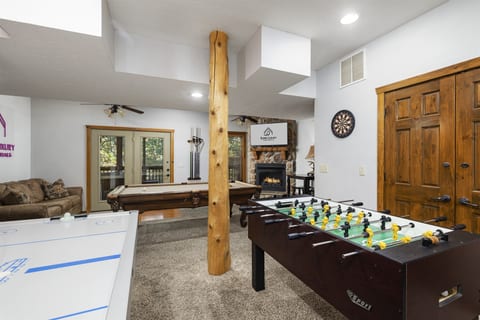 Basement Level: Foos Ball Table, Pool Table, Air Hockey Table in Family and Game Room with fireplace