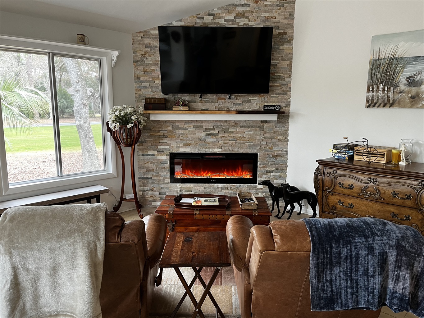 65” SmartTv above Electric Fireplace