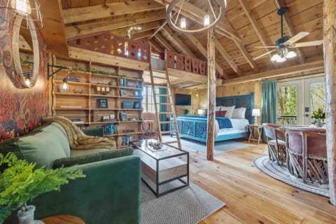 Open concept second level with dining area, kitchen, sitting area, and bedroom area. There are two lofts as well; one on the front and one over the kitchen.