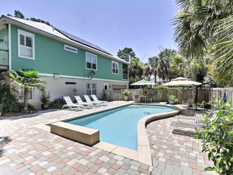 Huge saltwater swimming pool with large deck area greets guests on arrival.
