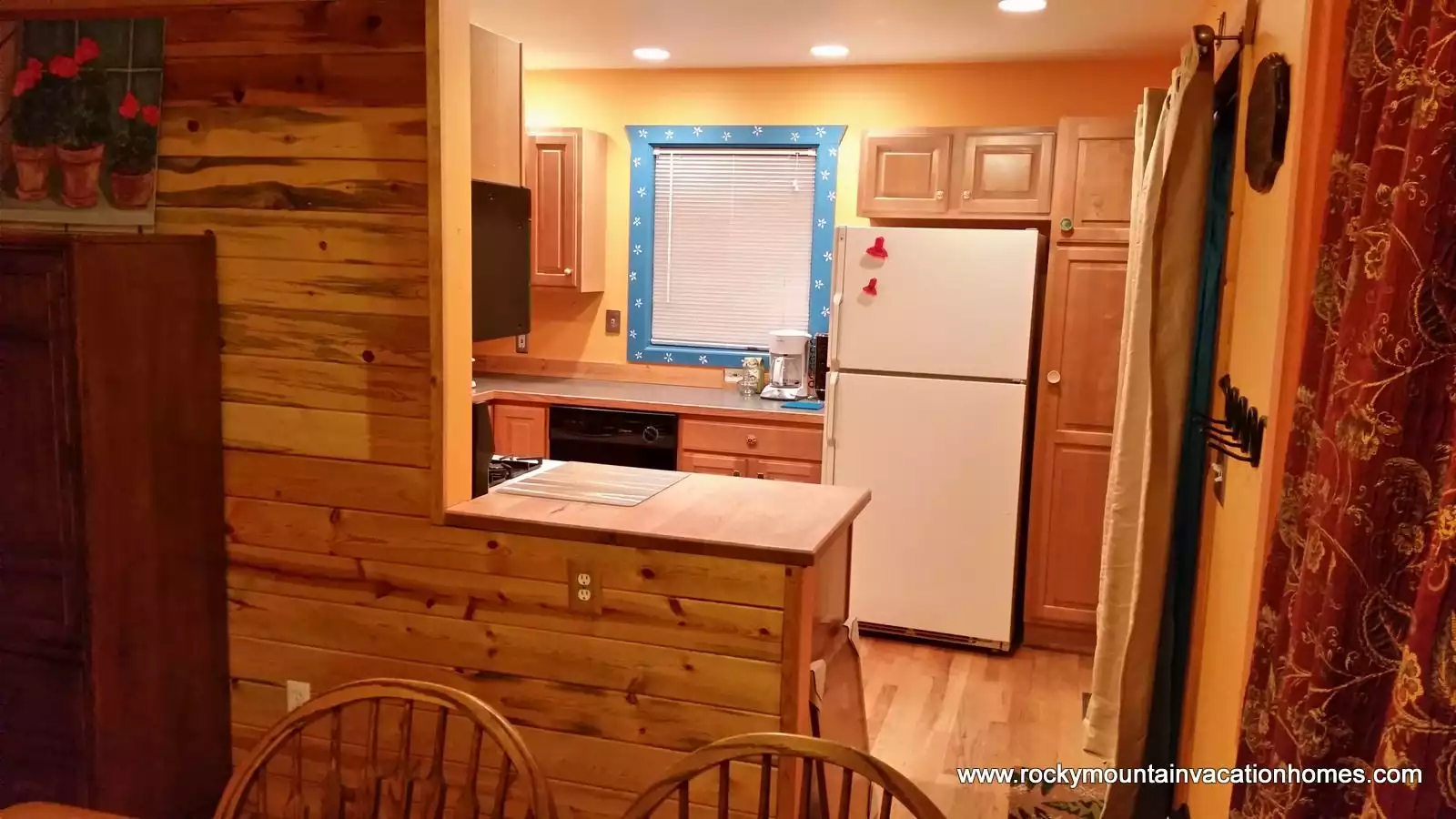 Kitchen from the dining area. Features a large built in butcher block