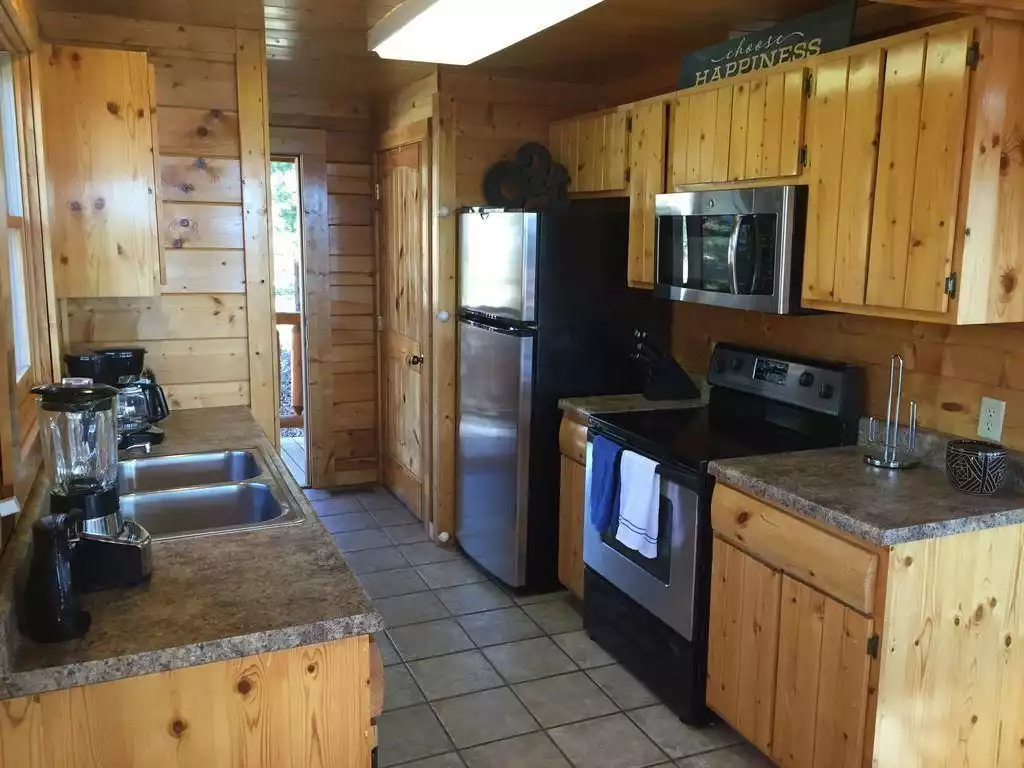 Kitchen with oven and dishwasher - Bear Hugs Cabin Mt Sunset Views Hot Tub Pool Table - Pigeon Forge