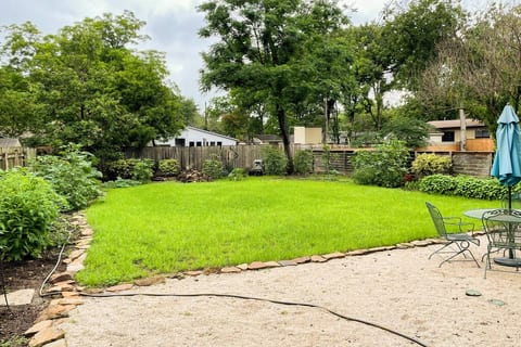 Back yard with a gas grill for your use for outdoor dining and hanging out.