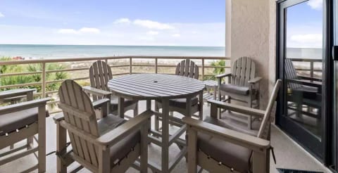 Large balcony over the ocean with dining for 6