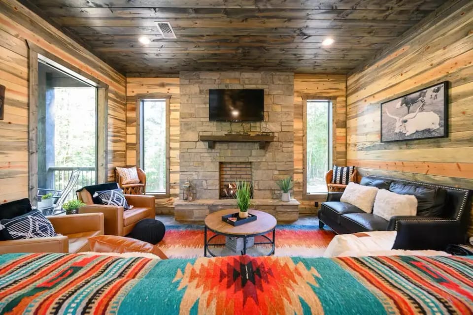 Relax around the big TV and indoor fireplace on comfy couches and chairs with cozy blankets and enjoy the vibrant modern southwest rugs and blankets! The couch is great for a quick nap between the fun activities in Broken Bow!