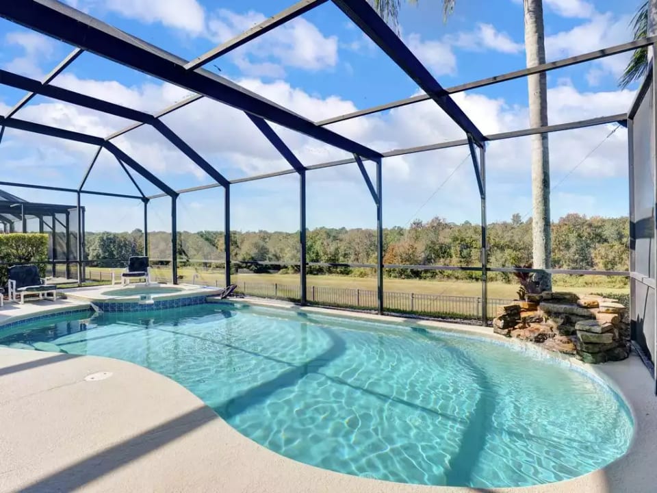 Extended lanai with heated pool, spa, and waterfall overlook conservation area