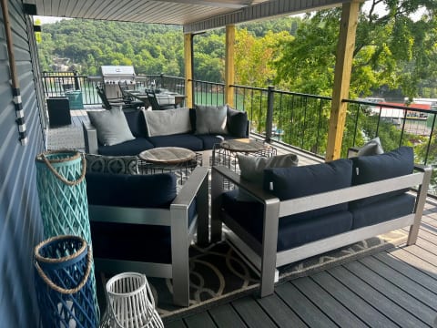 Upper Deck with couches, dining table, and grill. Amazing 180 view of the lake