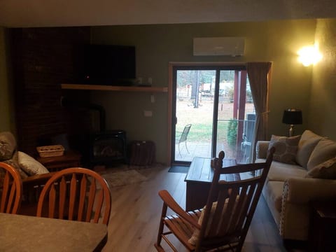 Living Room with ceiling fan, propane stove, mini-split, and smart TV with cable Room