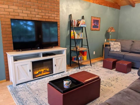 55" TV, fireplace, kid books and toys, tray top ottoman
