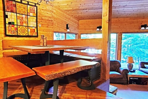 Dining area with live edge benches, seats 10+ people.