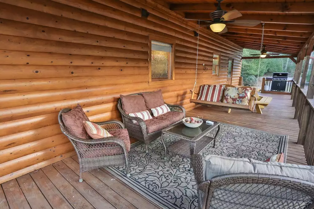 Enjoy the swing, wicker sofa and chairs and custom-built table for 8, and BBQ.