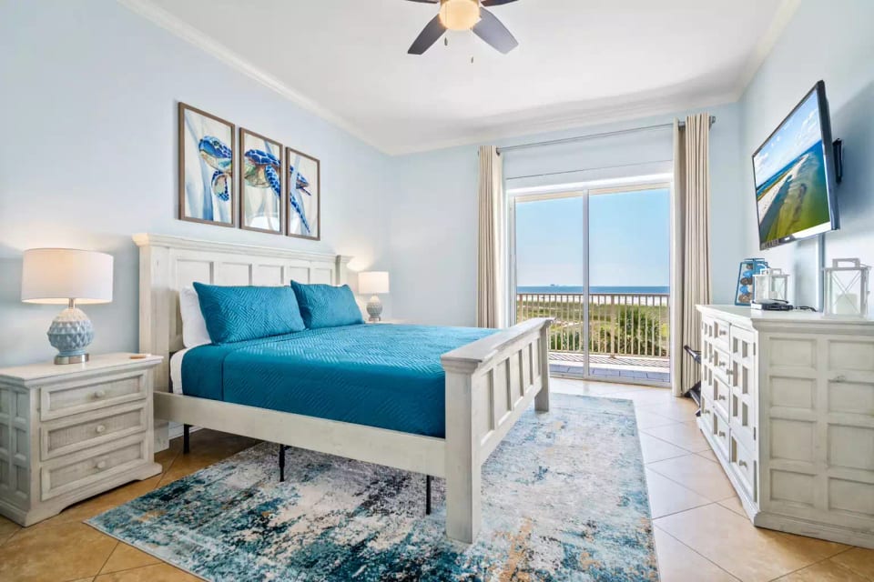 Master bedroom with king bed and Helix Sleep mattress. Private balcony overlooking the pool and Gulf of Mexico.