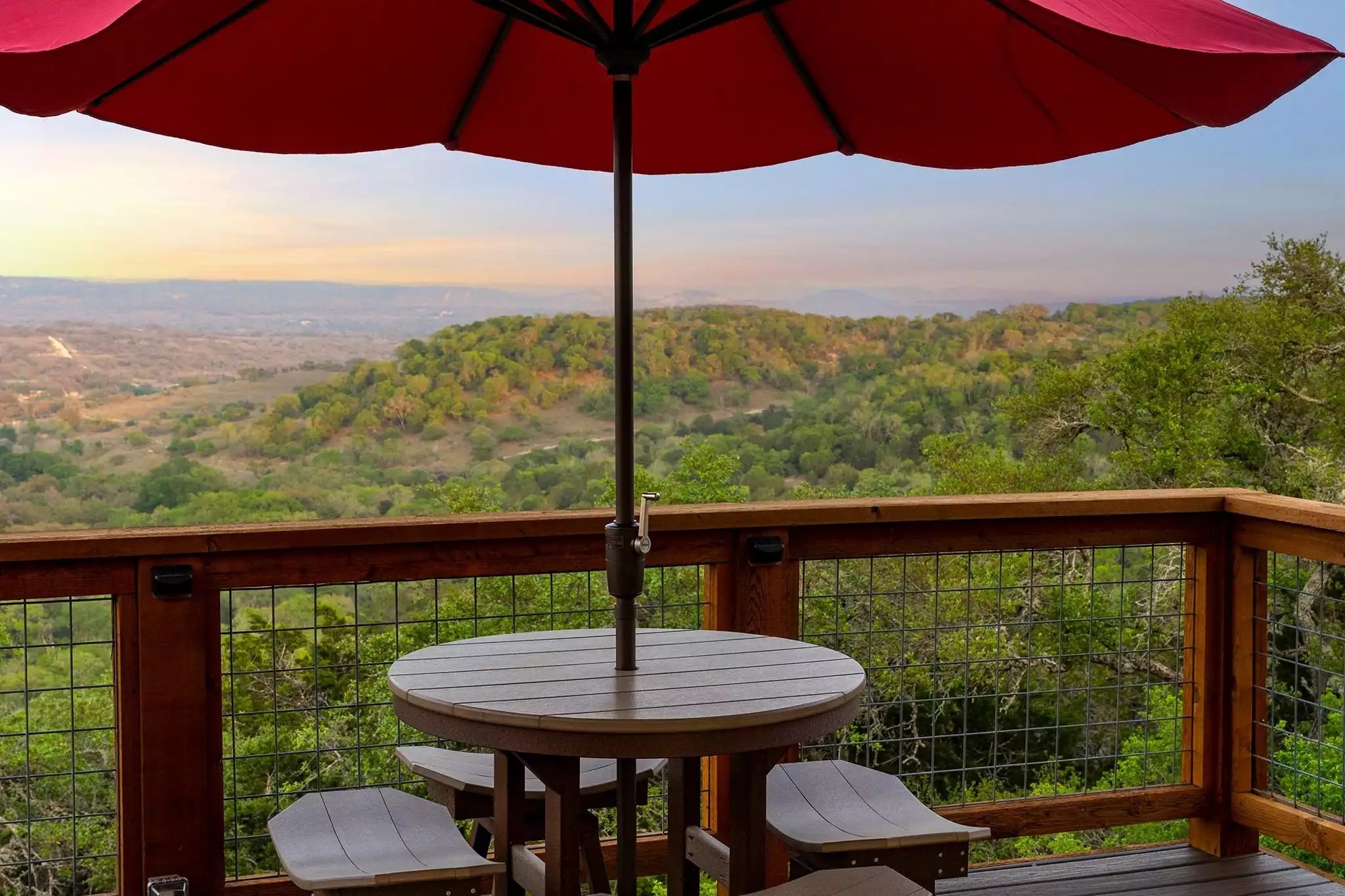 Table and stools looking onto the valley below. Table and stools looking onto the valley below. - GWR-Private-AmazingHilltopView-HotTub-FirePit-Pool - Fredericksburg