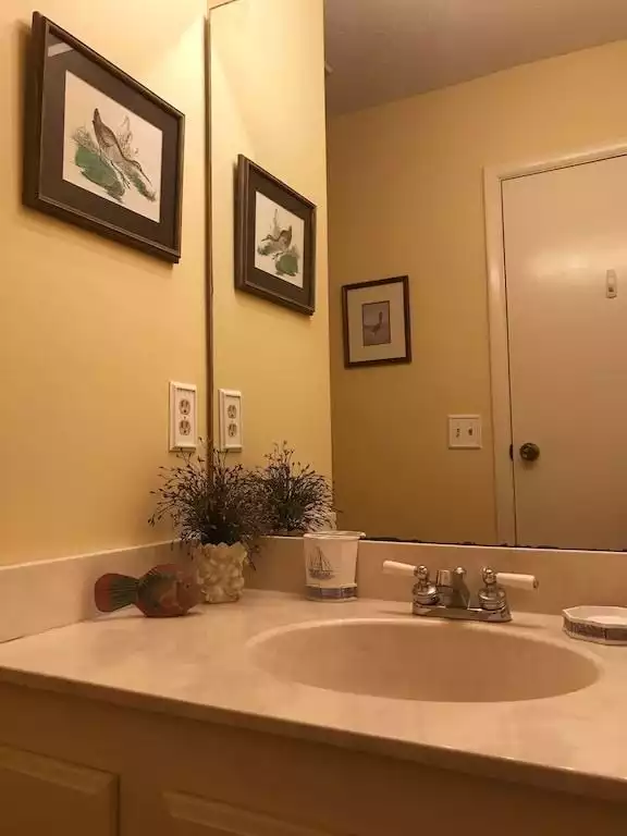 Half bath conveniently located off the kitchen. - Seas The Day - Saint Simons Island