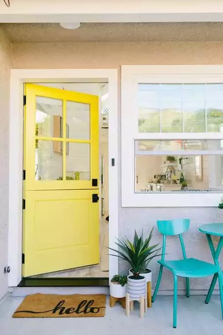 A crisp yellow dutch door welcomes guests to #tinyhome living.  Welcome to the Magic Mountain Bungalow!