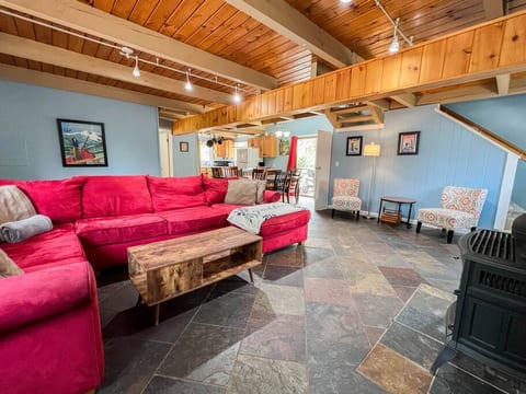 Large and inviting living room on main level with sectional sofa and gas stove