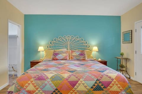 The master bedroom, inspired by the colors of the Caribbean, with comfy king size bed, ensuite bathroom, walk in closet, USB charging cables, and plenty of storage.
