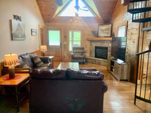 Main level living room with fireplace and smart tv