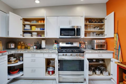 Completely stocked chef's kitchen, with crockpot, toaster over/air fryer, blender, popcorn popper, cookware, casserole dishes, and everything else you could possibly need.