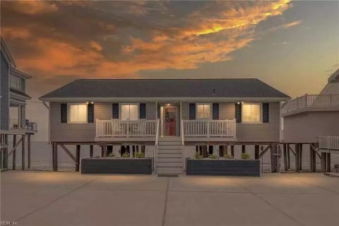 The front of this charming home with a fun front porch full of character. As you can see it is right on the water. There is also a foot washing station before you walk up the steps so you don't have sand in your house the entire stay.