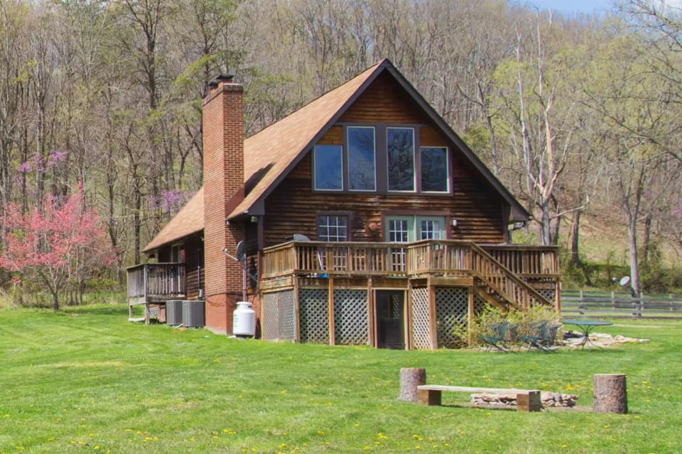  View of the firepit and cabin on a beautiful lawn