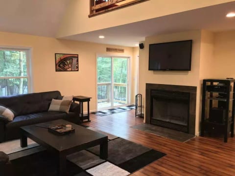 Spacious living room with entertainment center and surround sound stereo.