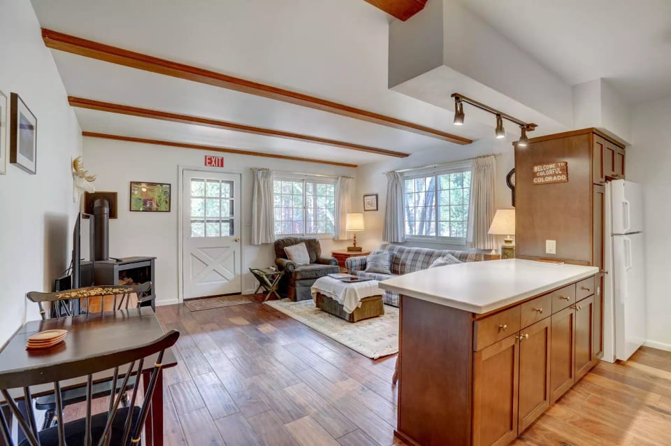 Main living space, comfy couch, chair, dining area and cozy fireplace