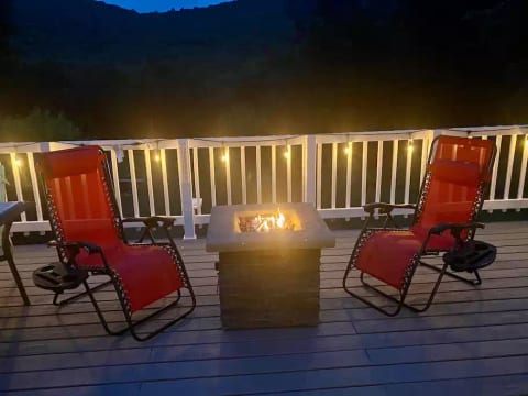 Propane fire pit and two zero gravity lounge chairs. Perfect chairs for catching some rays of sunshine or star gazing at night.