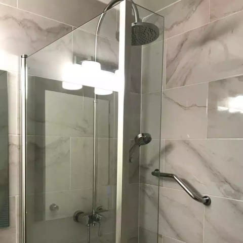 Monsoon and spray shower heads over bath. Grab bars.