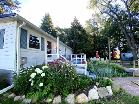 Main entrance at the back door. Large patio with picnic tables and grill. Beautiful views from the deck and patio.