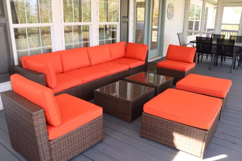 Relax and enjoy the lake on the screened in porch from the couch or the dining table!