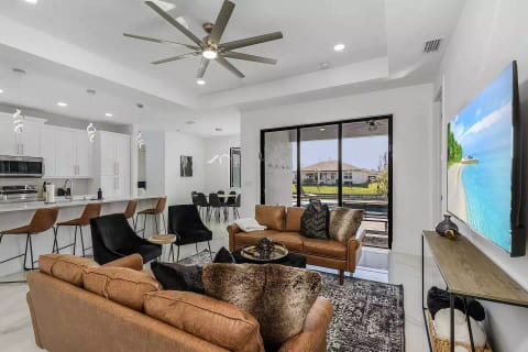 Upon entering, the great room captivates with its stunning view.