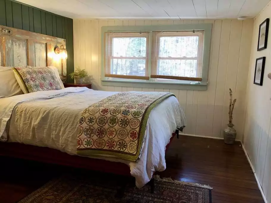Bedroom #1 with a queen bed and comfy linen bedding.  Bedroom has a small closet. - Camp Pocomoonshine - Cozy/Lake Access/Hot Tub - Keeseville