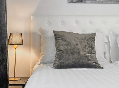 Beautiful night time reading lights next to the beds! You will enjoy sleeping in these beds with satin sheets! Welcome to Residential Hotels Kamppi.