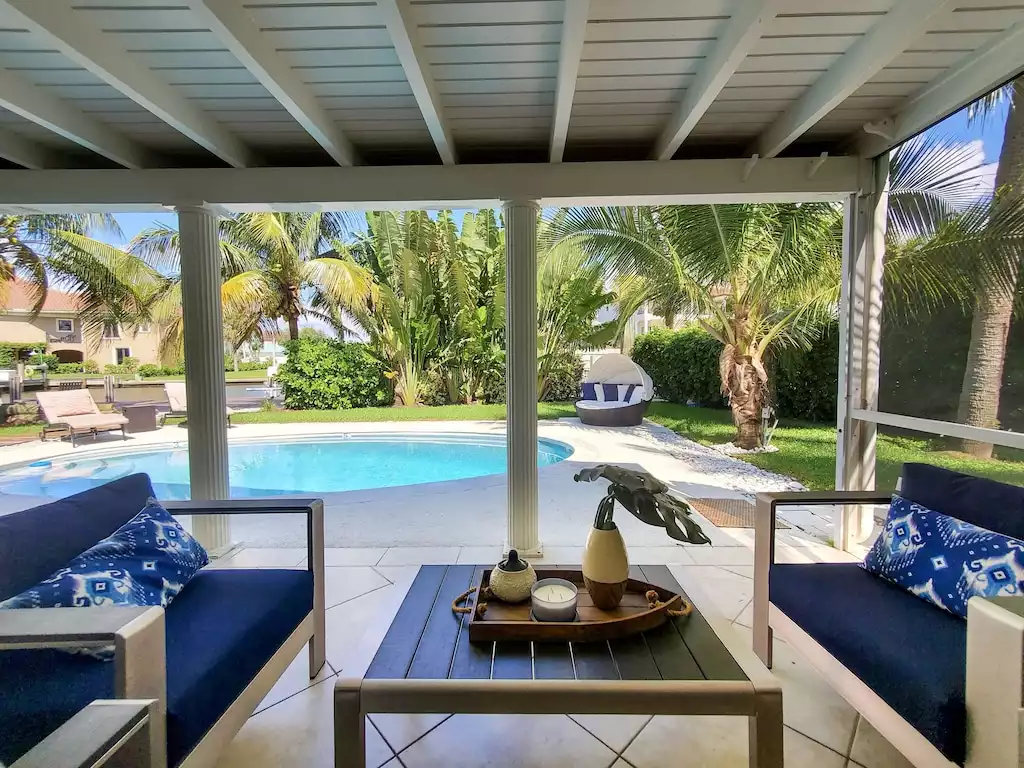 Outdoor seating area under covered lanai.