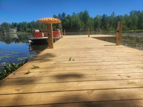 “Take a stroll down your sturdy, 8-foot-wide love-walk — a brand-new dock built for sunset chats, shared snacks, and stealing kisses over the water. And if you want to level up date-day? The pontoon boat can be included.”