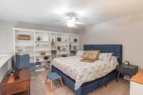 Primary bedroom suite (upstairs) featuring king sized euro-hybrid mattress, smart TV, two closets, attached full bath with tub/shower combo.