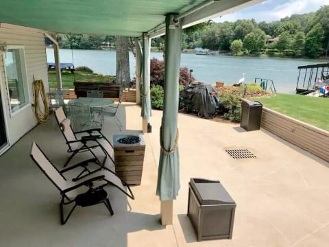 A huuuuge patio with a wrap-around deck is your outdoor dining room, providing a panoramic view of the lake and mountains. The hanging swing and grill are steps away.