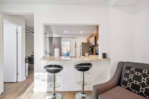 View of bar, living room and kitchen. Open floor concept.