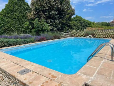 The pool in the walled garden, surrounded by lavender and flowers